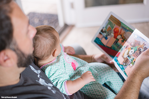 Man reading to a baby