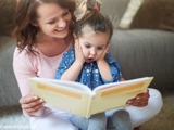 Mother reading to daughter