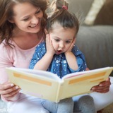 Mother reading to daughter