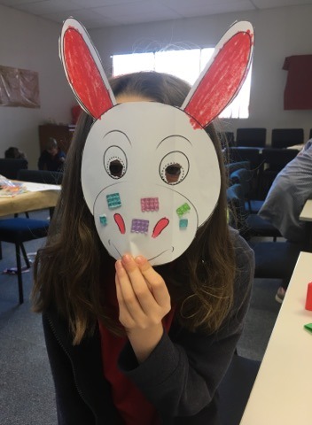 Child wearing a donkey mask